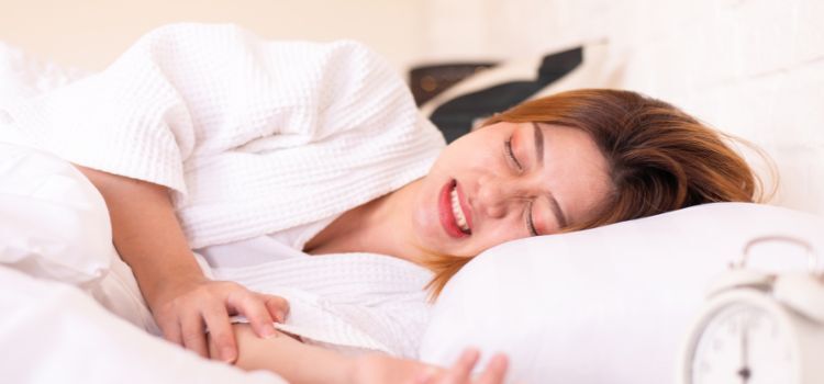 Asian woman sleeping on the bed and grinding teeth,Female bruxism
