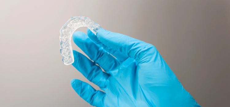 an image of a Custom-fit dental night guard held by a dentist