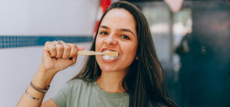 Portrait of Woman Brushing Teeth too hard