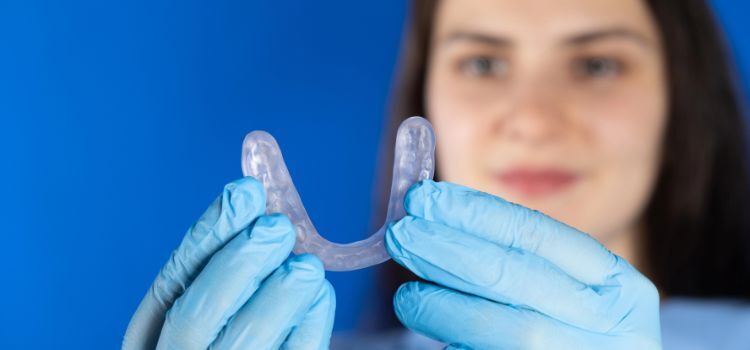 Dental professional holding a custom night guard